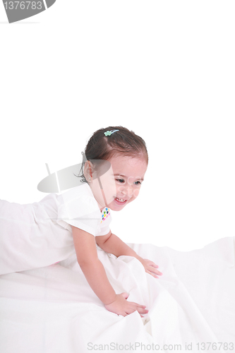 Image of cute little girl on the bed at home 