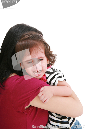 Image of Little girl crying in mothers arm, isolated on white