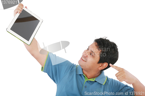 Image of Laughing casual young man holding a touch pad tablet pc on isola