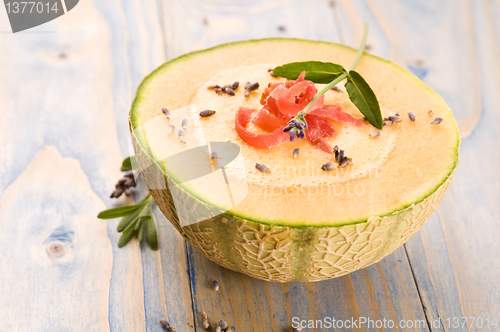 Image of fresh melon soup with parma ham and lavender flower