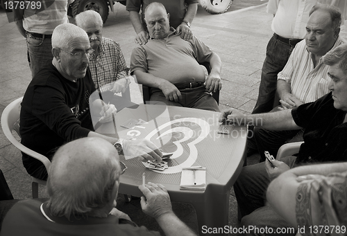 Image of Men playing cards