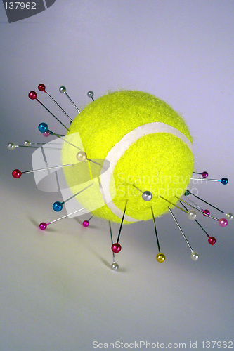 Image of tennis ball on needles