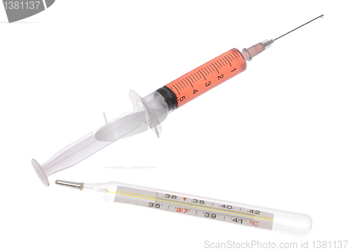 Image of Medical thermometer and syringe. 