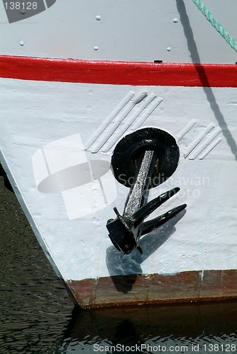 Image of Black anchor on a white boat