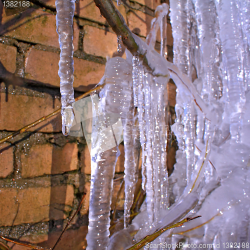 Image of blue icicles near brick wall