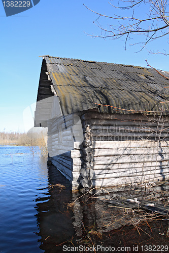 Image of rural wooden house amongst spring flood