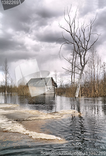 Image of old wooden house in water