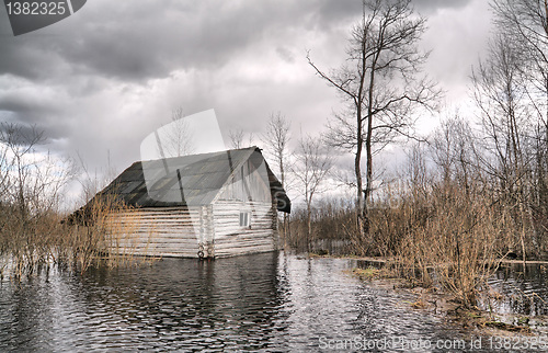 Image of old wooden house in water