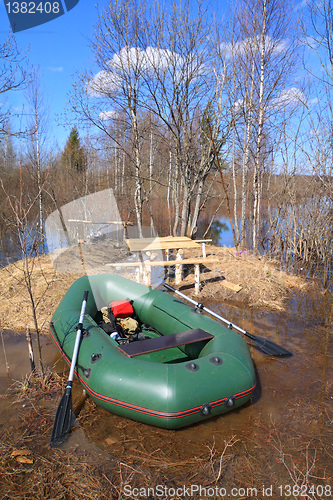 Image of green rubber boat near coast