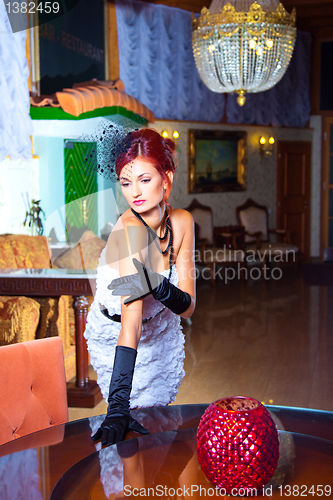 Image of glamour woman in vintage hall interior