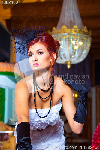 Image of glamour woman in vintage hall interior