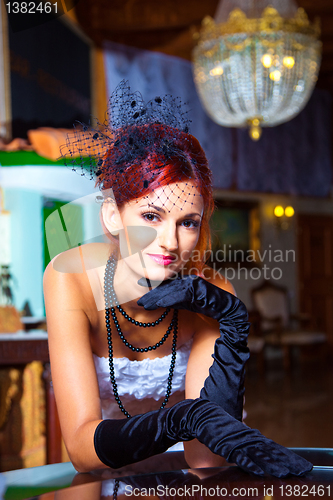 Image of glamour woman in vintage hall interior