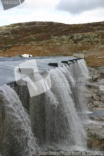 Image of water flows out of the dam on the Hardangervidda in Norway