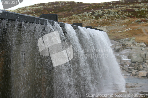 Image of water flows out of the dam on the Hardangervidda in Norway