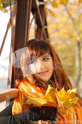 Image of Beautiful girl with fallen leaves