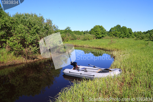 Image of rubber boat on coast river