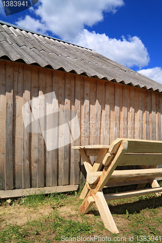 Image of wooden bench near wooden wall 