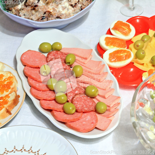 Image of varied food-stuffs on white tablecloth