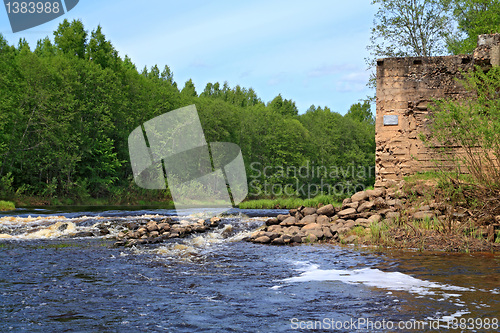 Image of aging destroyed dam on small river