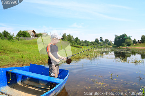 Image of boy fishes on coast river