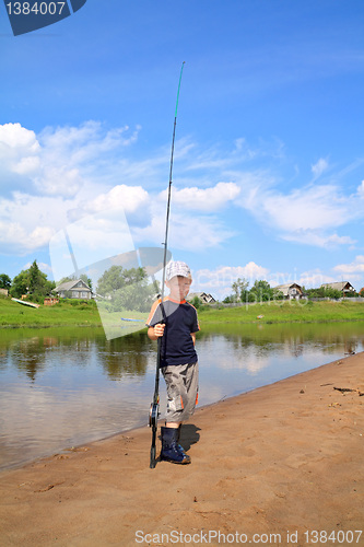 Image of boy fishes on small river