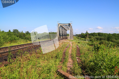 Image of old railway bridge through small river 