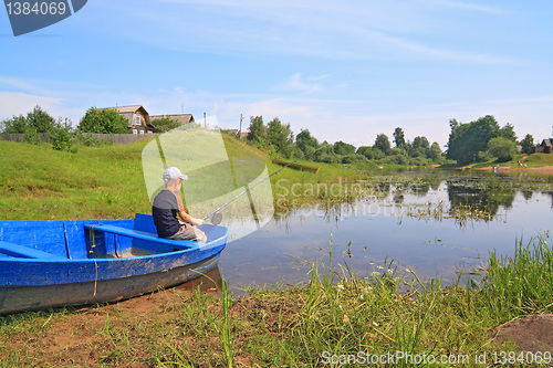 Image of boy fishes on coast river