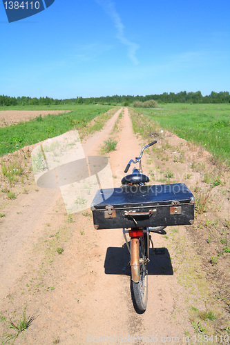 Image of old valise on old bicycle