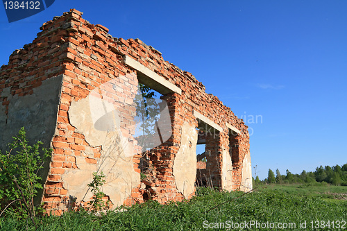 Image of destroyed brick wall amongst 