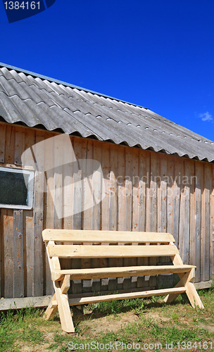 Image of wooden bench near wooden wall