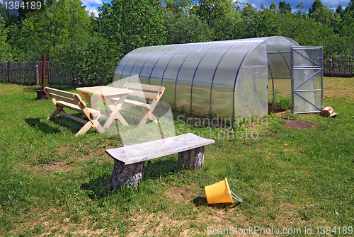 Image of new bench near plastic of the hothouse