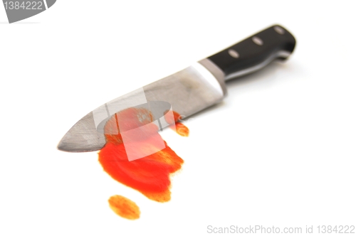 Image of knife with red blood from murder