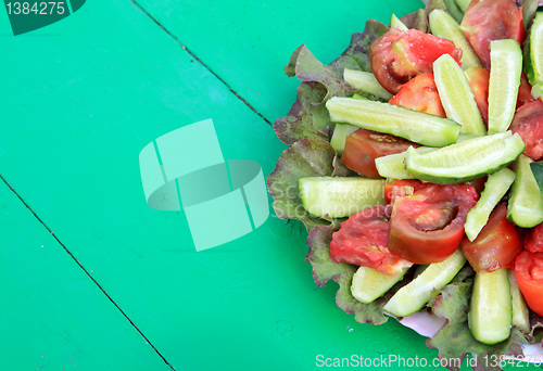 Image of vegetable salad on green wooden table