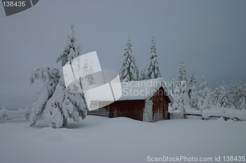 Image of red cottage in winter landscape