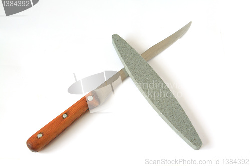 Image of knife and emery on white background
