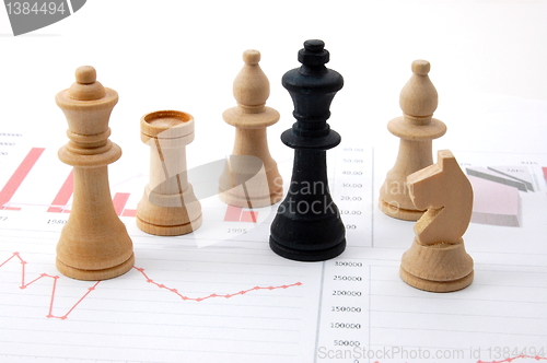 Image of chess man over business chart