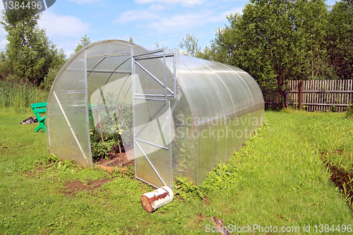 Image of plastic hothouse in rural homestead