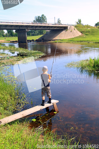 Image of boy fishes on small river