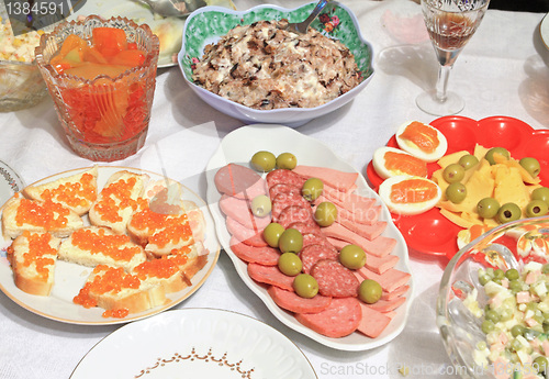 Image of varied food-stuffs on white tablecloth
