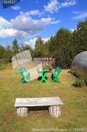 Image of wooden furniture in summer garden