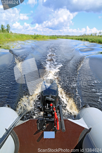 Image of motor boat on small river