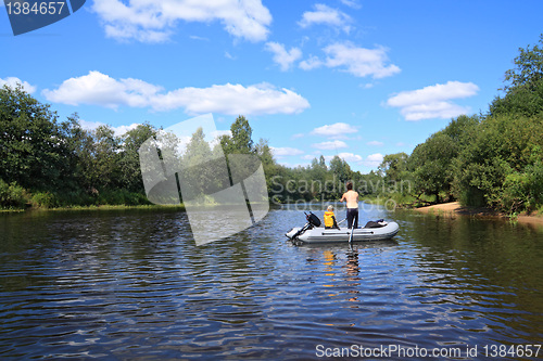 Image of two boys ride on boat