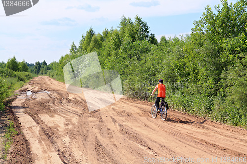 Image of boy on bicycle on rural road