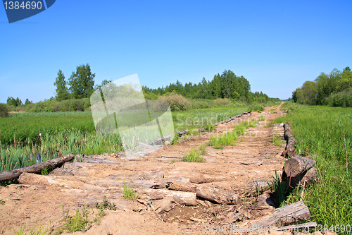 Image of rural wooden äîðîíà through marsh