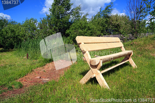 Image of wooden bench in summer park