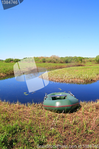 Image of rubber boat on coast river