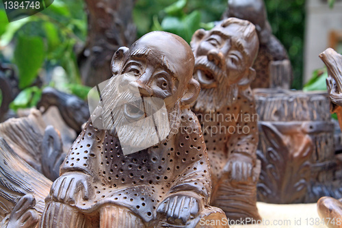 Image of two wooden toys on green background