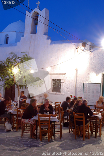 Image of taverna at night by church