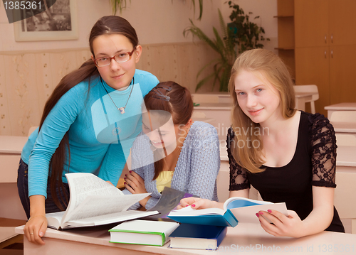Image of Three girls schoolgirl getting ready for the lesson