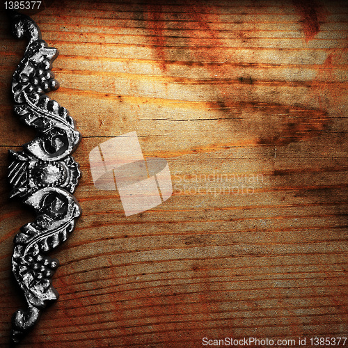 Image of iron ornament on wood